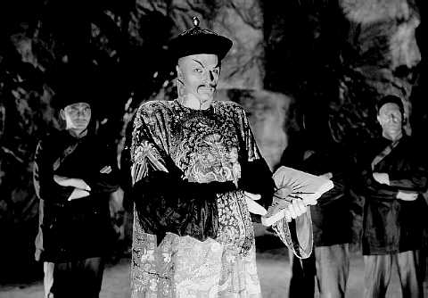 Fu Manchu (Henry Brandon) and his faithful Dacoits